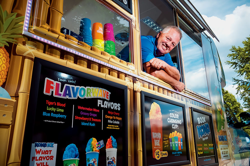 COOL DOWN: Franchisee co-owner Jack Ewing is surfing the Flavorwave after receiving his self-sufficient Kona Ice truck this summer.