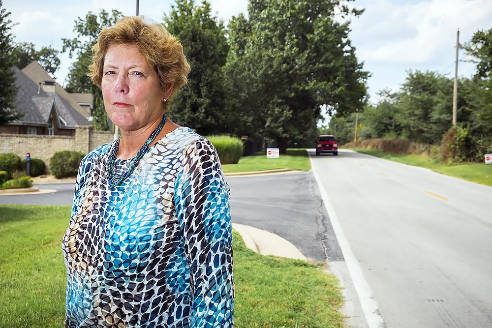 TAP THE BRAKES: Jane Paul stands on the shoulder of Kansas Avenue, a two-lane street the county plans to expand. Her North-South Corridor Alliance opposes the project.