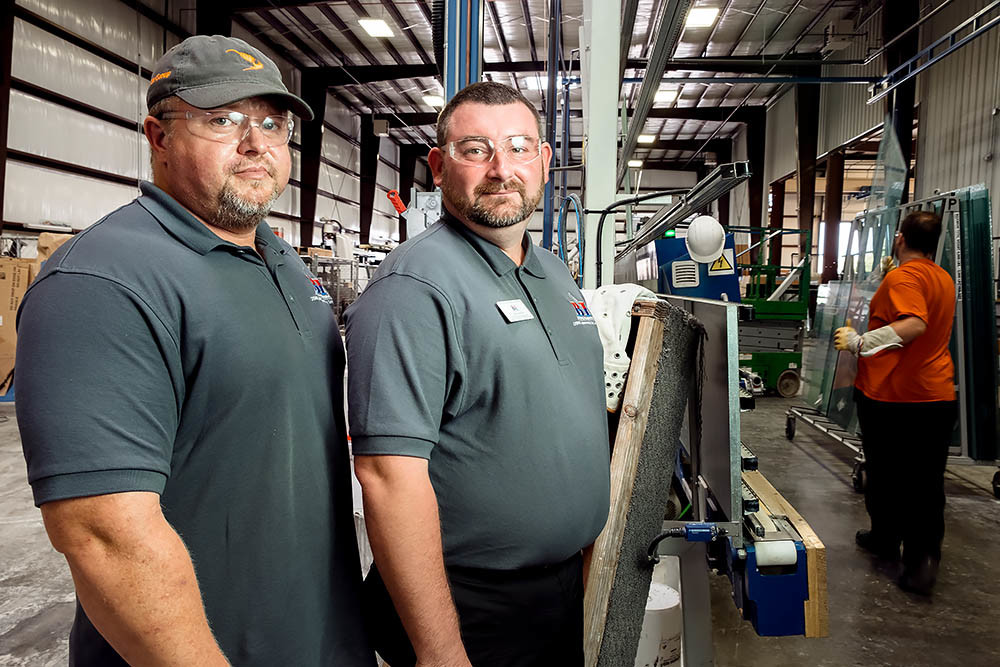 RULES RULE: Brittney Inc. staff members Brandon Reese, left, and Joe Austin say clients like American Glass Inc. lean on them for federal regulatory changes.