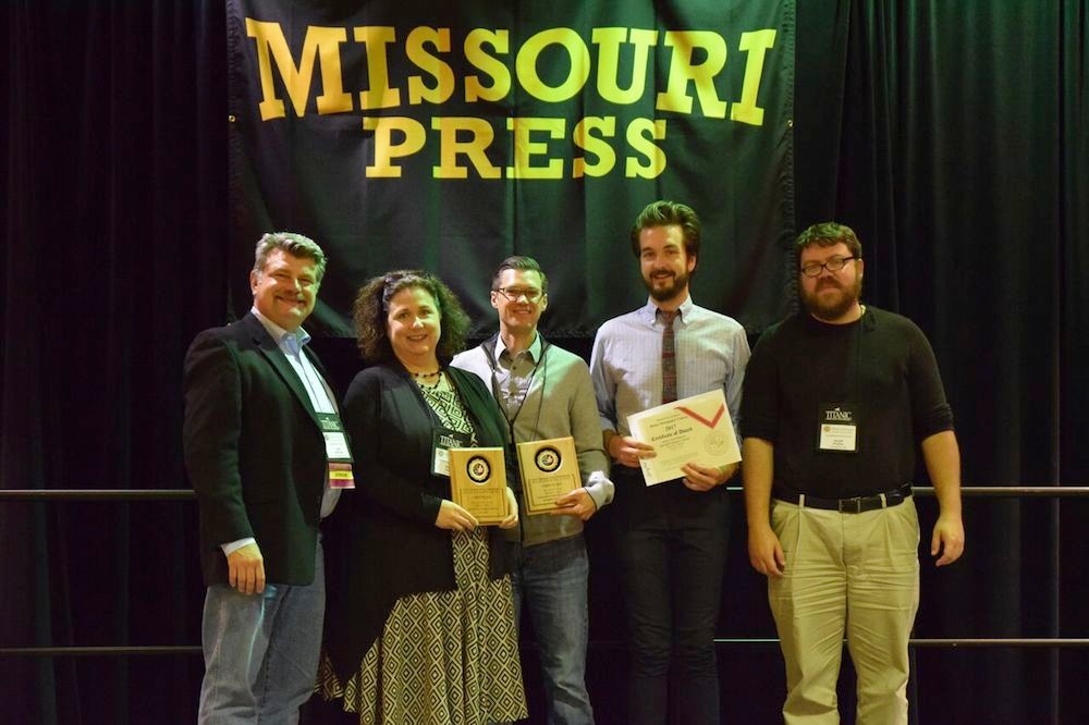 Missouri Press Association President Jeff Schrag, at left, presents four awards to Springfield Business Journal Publisher Jennifer Jackson, Editor Eric Olson, Editorial Designer and Photographer Wes Hamilton and Web Producer Geoff Pickle.
