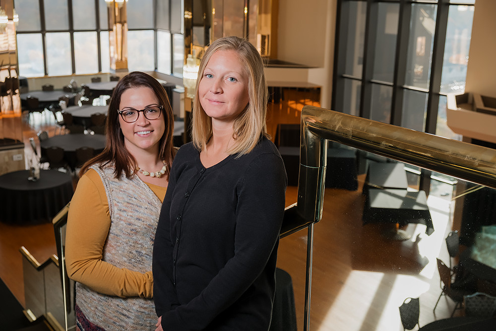 New employees Ashley Little, left, and Anna Barbee are responsible for booking reservations and managing events at the new JQH Tower Club.