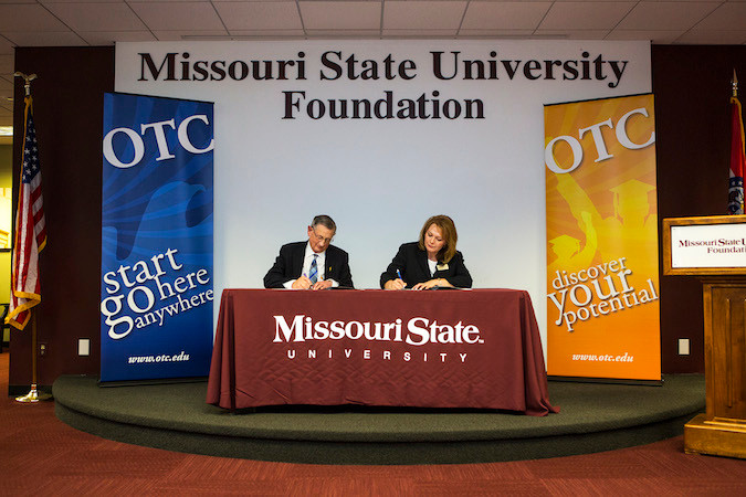 Missouri State University Provost Frank Einhellig and Ozarks Technical Community College Provost Tracy McGrady sign an honors program articulation agreement.