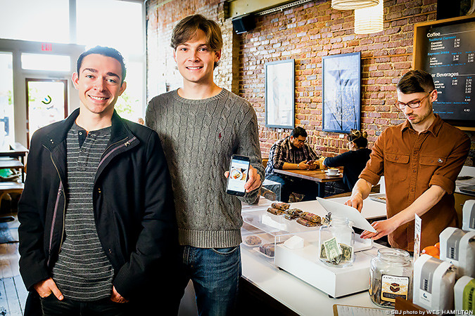 IN LINE: The Coffee Ethic is among 20 local businesses using Reaction, a customer survey app produced by Brent Borelli, far left, and Stuart Emerson.