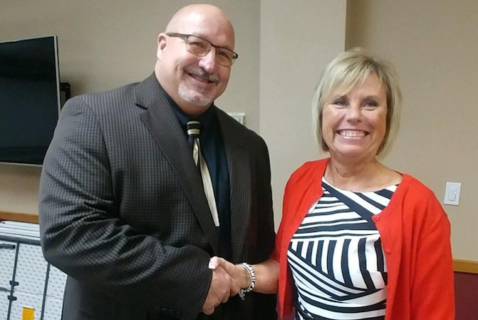 Ozark Board of Education President Patty Quessenberry congratulates Superintendent Kevin Patterson on his contract extension.Photo provided by OZARK R-6 SCHOOL DISTRICT