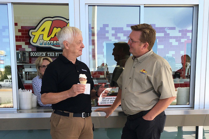 Former Skateport owner Ted Hall visits with Andy’s Frozen Custard co-owner Andy Kuntz during the opening of the company’s newest store.