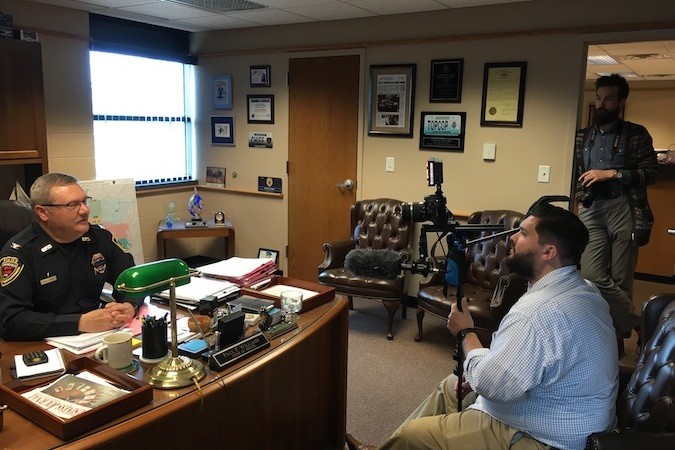 In his office, Police Chief Paul Williams answers questions from SBJ videographer Jeremy Bartley as photographer Wes Hamilton listens and scopes out shots.