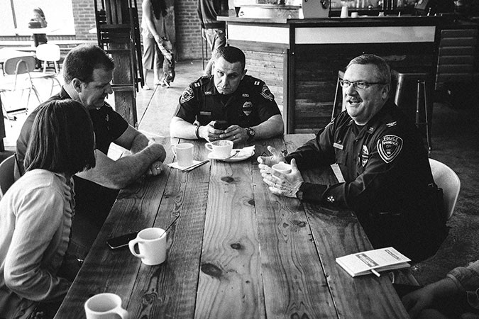 During Coffee with the Chief at Kingdom Coffee, Paul Williams, right, talks shop with Police spokeswoman Lisa Cox and Cpts. Ben King and Greg Higdon.