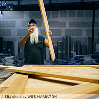 Berlin Coble trims lumber to fit a high-end Biltmore custom door.