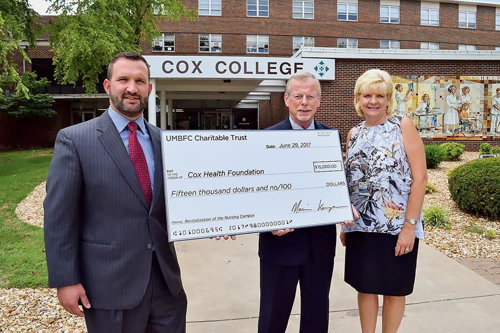 Aaron Emel, market president of UMB Bank’s Missouri South Region, presents a ceremonial check to Dr. Bob Lunn, interim president of Cox College, and Lisa Alexander, president of the CoxHealth Foundation. UMB’s charitable trust donated $15,000 toward the revitalization of the north-side Springfield nursing campus. The $6.6 million fundraising campaign will completely update the campus built in 1961.Photo provided by COXHEALTH