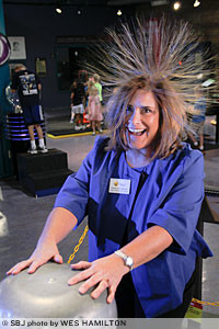Charlotte McCoy enjoys a hair-raising experience at one of the Discovery Center's exhibits at 438 E. St. Louis St.