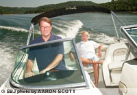 Creagh Tucker, member services director for Branson Boat Club, pilots co-owner Jay Finley III in one of the club's SeaRays on Table Rock Lake.