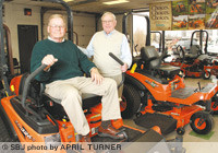 Ozark Power Center General Manager Randy Hoffman and owner Charles Edel show a lawn mower off the Kubota Tractor Corp. line, one of the companies' main brands.