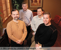 Healthcarefirst employees including, from left, Patrick Logan, John Heslin, Chad Albert and CEO Bobby Robertson, will move later this year to a larger building in Ozark.