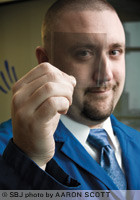 Brewer Science's Steve Turner holds an example of the company's carbon-nanotube-based transparent conductive film. Brewer received federal funds to research the technology, which can be applied to touch screens, LED lighting and solar panels.