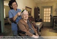 Ana Narvaez, a caregiver with Home Instead Senior Care, visits Sue Moore's home to help her with nonmedical tasks, such as housekeeping and grooming.