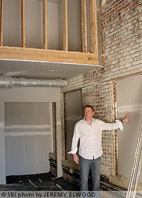 Matthew Miller shows one of the two-story lofts under construction at Wilhoit Plaza.