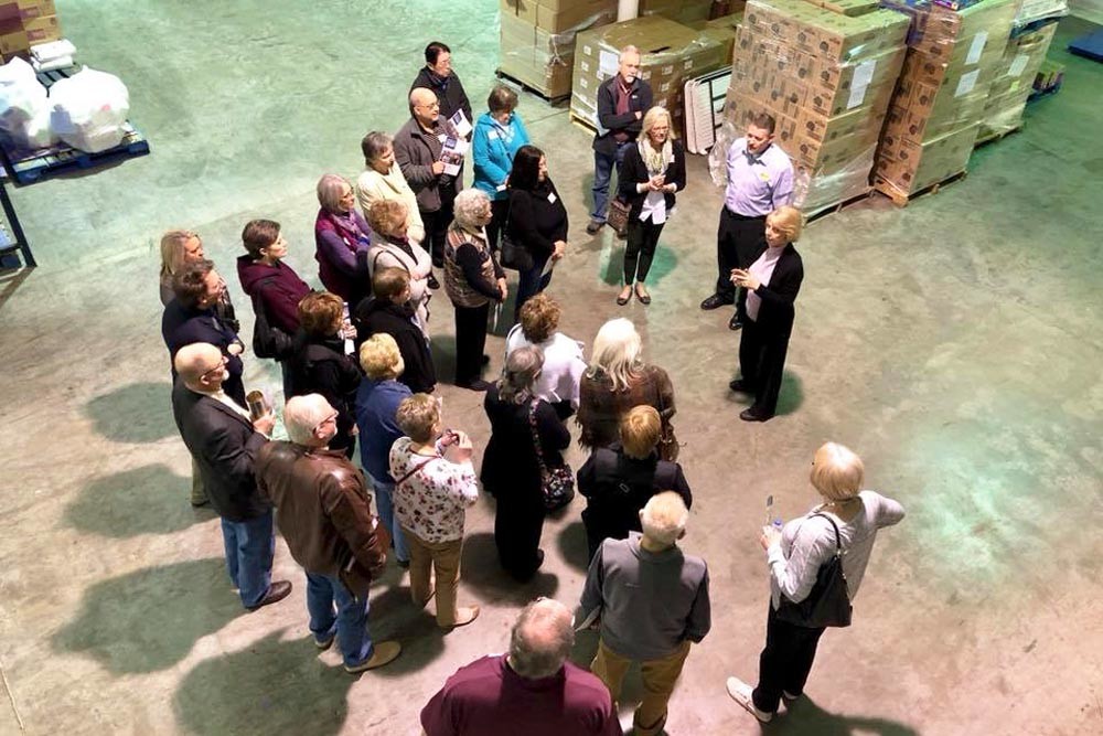VOLUNTEER MATCH
Participants of the city’s Give 5 volunteering program for retirees visited 23 nonprofits during the second session that wrapped up March 29. Above, Diaper Bank of the Ozarks Director Jill Bright addresses the group inside the Council of Churches’ warehouse.