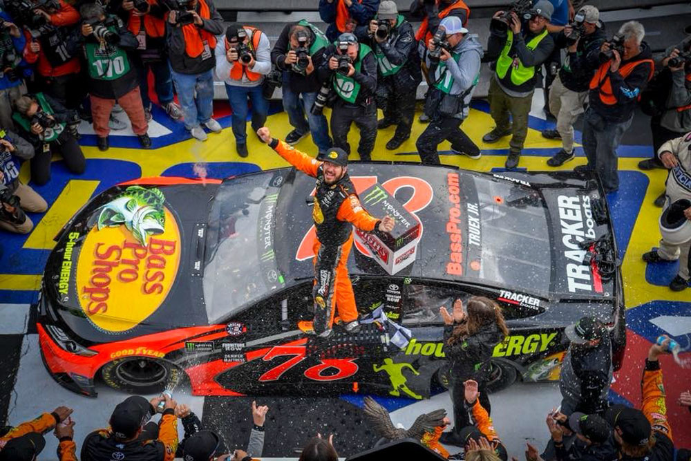 On Top
NASCAR driver Martin Truex Jr. on June 3 celebrates his victory at the Pocono 400 stock car race, an annual Monster Energy NASCAR Cup Series event held at Pocono Raceway in Long Pond, Pennsylvania. Truex, a Furniture Row Racing driver, crossed the finish line in his No. 78 Toyota Camry decked out with Bass Pro Shops branding on the hood. Bass Pro in October extended its sponsorship of Truex for a third year.