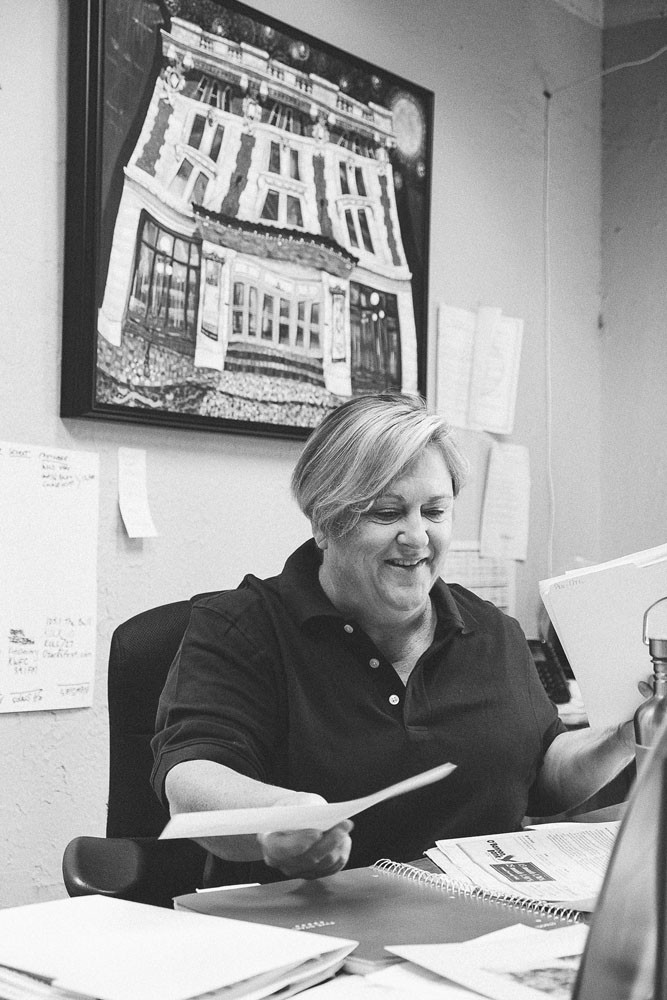 Domann organizes her desk in her Springfield Little Theatre office, where she’s worked for more than 21 years.