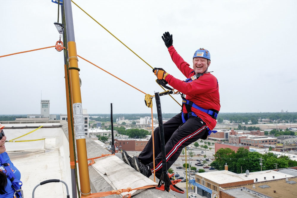 All Out
For the Child Advocacy Center’s annual Over the Edge fundraiser, Jack Henry Banking President Stacey Zengel prepares to rappel down downtown’s Sky Eleven building. On June 2, 73 people rappelled down the building to support the children’s charity. CAC netted more than $180,000 from the fundraiser, which went through the end of June.
