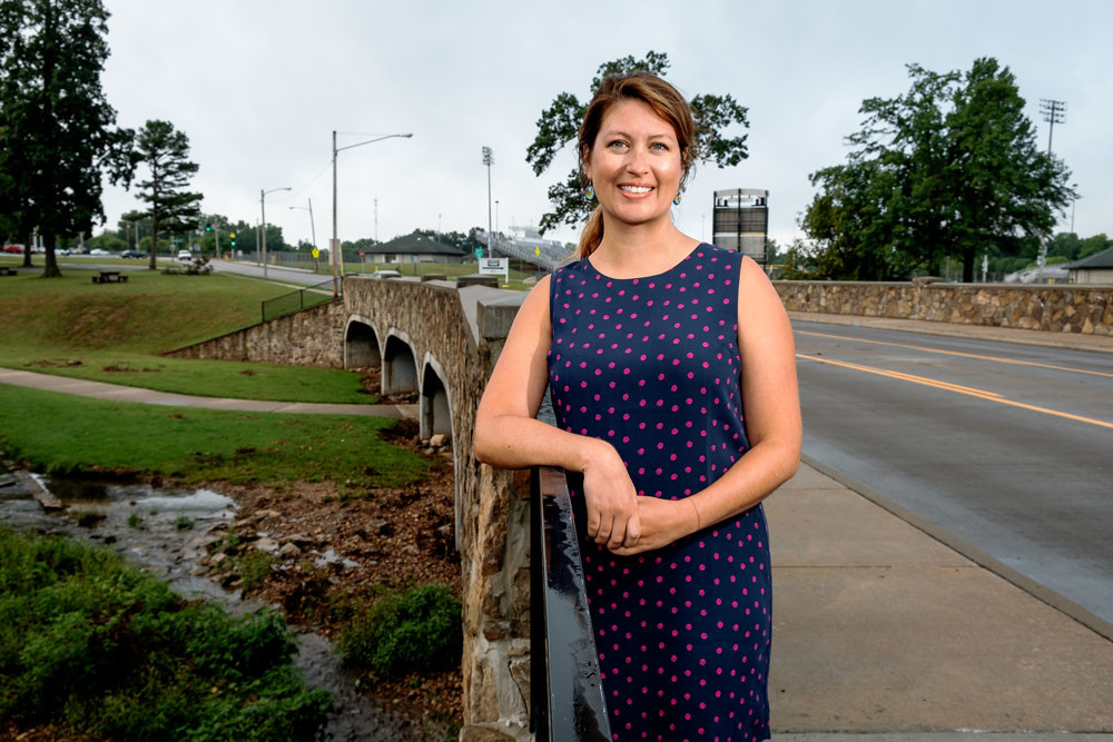 Ozark Greenways Executive Director Mary Kromrey in August 2018 poses next to the Fassnight Creek Greenway, which will be improved as part of the new grant.