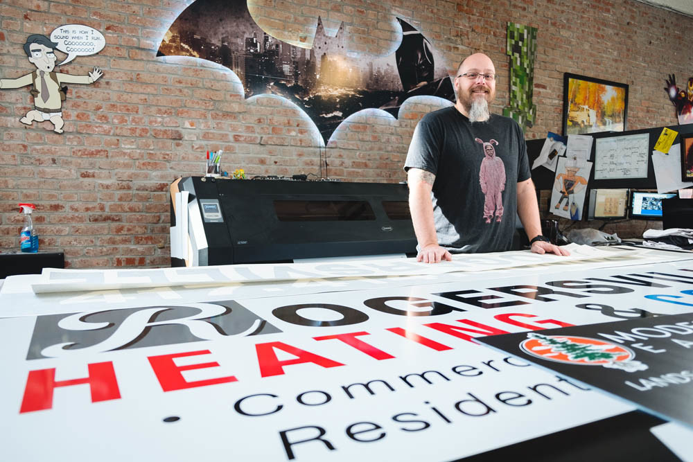 GETTING CREATIVE: Turning a job loss into an opportunity a decade ago, Joshua Hill runs his graphic design business in downtown Rogersville.