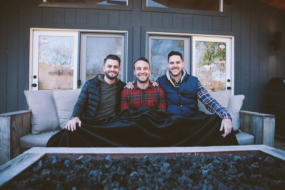 From left, Josh Stewart, Bryan Simpson and Dane Watts demonstrate Big Blanket Co.’s flagship product.