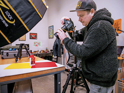 Setting up the Shot: Geoff Ridenour, photographer and production manager for Punchbowl Studios, a Fried Design in-house content production studio, prepares a marijuana product promotion for a client. “So much of what we get hired to do is people want it to be super cool,” Sullivan says.