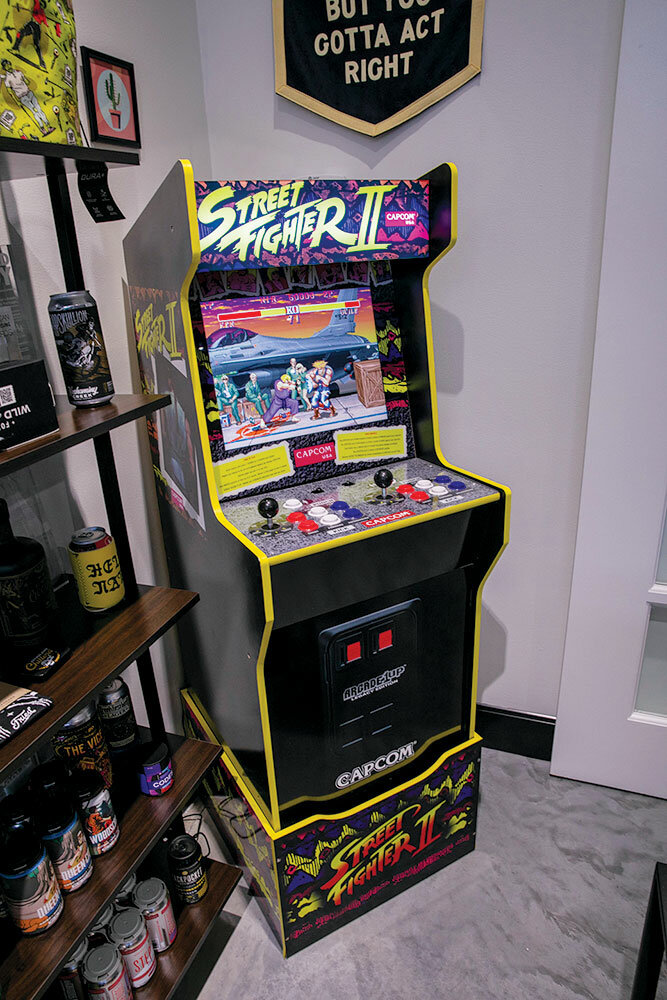 Game On: An arcade cabinet in the lobby has Street Fighter II ready to go, and a shelf shows off some of the company’s designs. Sullivan says clients over the years have included Sweet Boy’s Neighborhood Bar, Team Taco, Mother’s Brewing Co., Big Whiskey’s and Easy Mountain Cannabis Co. “We specialize in vice. We work in a lot of really highly regulated industries,” Sullivan says.