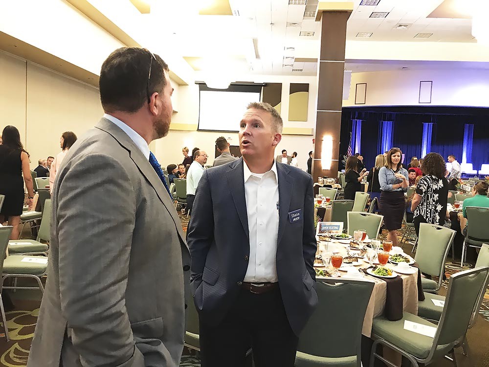 Roughly 450 people attended Springfield Area Chamber of Commerce’s annual Membership Luncheon on Aug. 9 at Oasis Hotel & Convention Center. Above, Missouri State University’s Jeff Schmedeke, left, and Arvest Bank’s Shane Cowger talk before the luncheon.