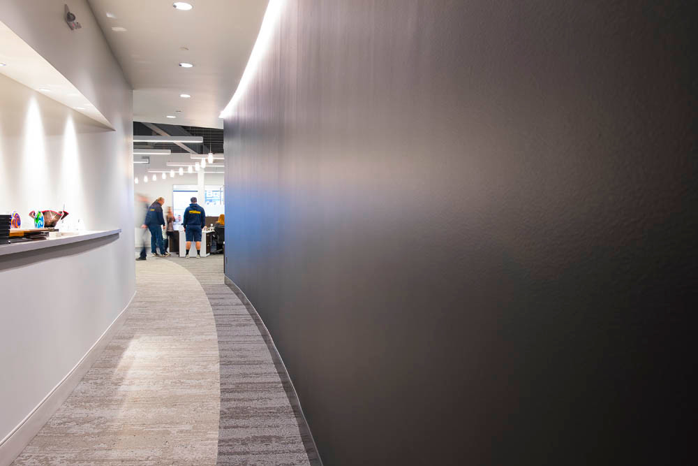 Cool Curves
A curved hallway with a cutout that will soon display the company’s accolades leads to an open floor plan.