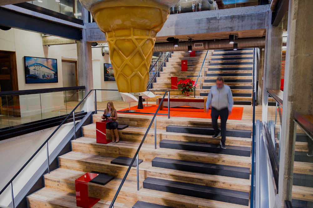 Namesake
Andy Kuntz walks down the stairs, while marketing specialist Kylie Wright sets up a laptop at an impromptu desk. “You don’t very often find a building that’s 100 years old and not all gummed up with 20 coats of paint,” Kuntz says.