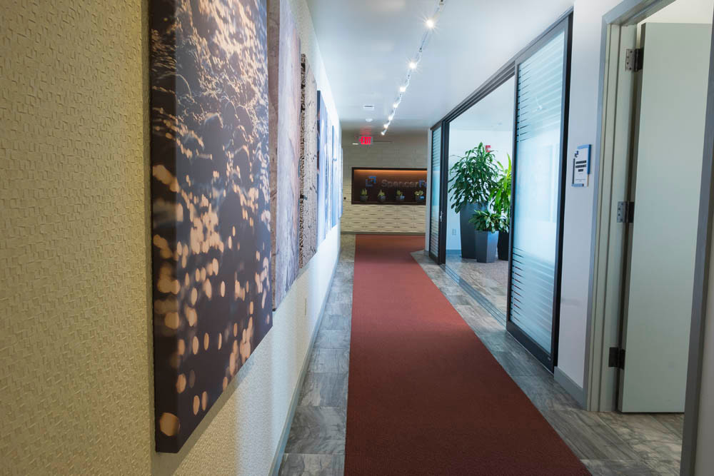 Tone
Quiet and peaceful, it’s easy to wonder if you’re in a commercial law office or a spa when walking down the main hallway. Earth hues set the tone, with pops of dark carpeting overlaying stone-textured tile.