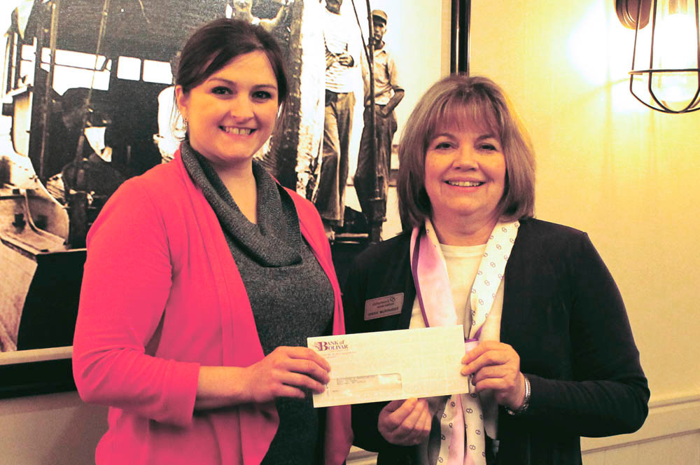 Bank of Bolivar Marketing Assistant Rachel Claunch, left, presents a $1,540 check to Marie Murphree of the Alzheimer’s Association. The bank split $5,900 in overall donations among four charitable organizations – the others being Harmony House, Miles for Smiles and Honor Flight of the Ozarks.