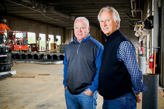 President and CEO Robert Low, left, and Vice President Steve Wutke stand in Prime’s $12 million plaza under development. SBJ photo by WES HAMILTON