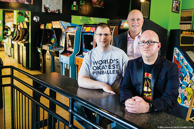 VINTAGE VIBES: 1984 owners Jason Durham, left, Devin Durham and Chris Stuart say arcade patrons can time travel toward the ‘80s.
