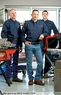 Keith Montle, regional manager; Steve Wohnoutka, owner; and Chad Clark, store manager