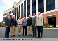 Lathrop &amp; Gage officials gather in front of their new office space after the firm announced the move in October.