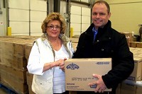 Ozarks Food Harvest Development Director Denise Gibson accepts a  donation from Matt Gentry, director of supply management for Land  O&rsquo;Lakes Inc., a first-time donor to the Springfield nonprofit.