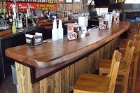 Two bars - made from a 100-year-old tree removed from Sequiota Park  about a year ago - at the eatery were constructed by Lampe-based Wood  Merchant LLC.Photo provided by WOOD MERCHANT LLC