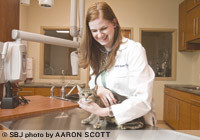 Dr. Molly Ramsey checks on a recently spayed cat at her 1,900-square-foot Nixa Animal Hospital, which was backed by roughly $300,000 in startup loans. Ramsey says she wrote a plan and stuck with it.