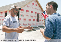 Contractor Darren Collins talks with Springfield Business Journal Editor Eric Olson about his motivation to rebuild his wife's salon so quickly after it was destroyed May 22. Below, the city issued Collins its first building permit nine days after the tornado.