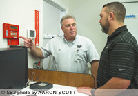 Federal Protection service technician Joe Carl outlines a security system's features with B.J. Jones, director of security for Family Pharmacy, which upgraded its security in 2007 after 13 break-ins.