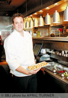 Houlihan's kitchen manager Myers Johnson prepares one of the restaurant's small-plate menu items.