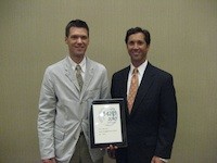 SBJ Editor Eric Olson accepts the paper's 2010 award from AABP board Vice President Larry Kluger during the national conference June 26.