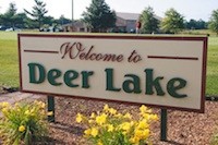 A golfer passes behind the Deer Lake Golf Course sign west of Springfield. The course and adjacent 107 acres were sold to Deer Lake Partners LLC, an investor group that has requested a zoning change for part of the property.