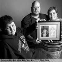 From left, Tyler, Rodger and Kim Hickerson are among the families featured in Randy Bacon's 'Mending of Hearts' photography exhibit, which aims to shed light on grief-support organization Lost & Found. They are holding a photo of their son and brother, Rodger, who was 14 when he died.