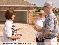 Bonnie and Sam Pusateri learn from Teresa Hall, left, about the amenities of a home in Autumn Corners. The Pusateries are looking for a home that requires less maintenance than their Kimberling City house.