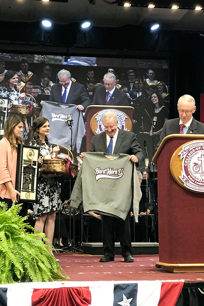 Forbes receives his Hard Work U. sweatshirt and handmade gifts from students. Earlier, Davis said, “There are no snowflakes here. We think that work ethic and free enterprise go hand in hand.”