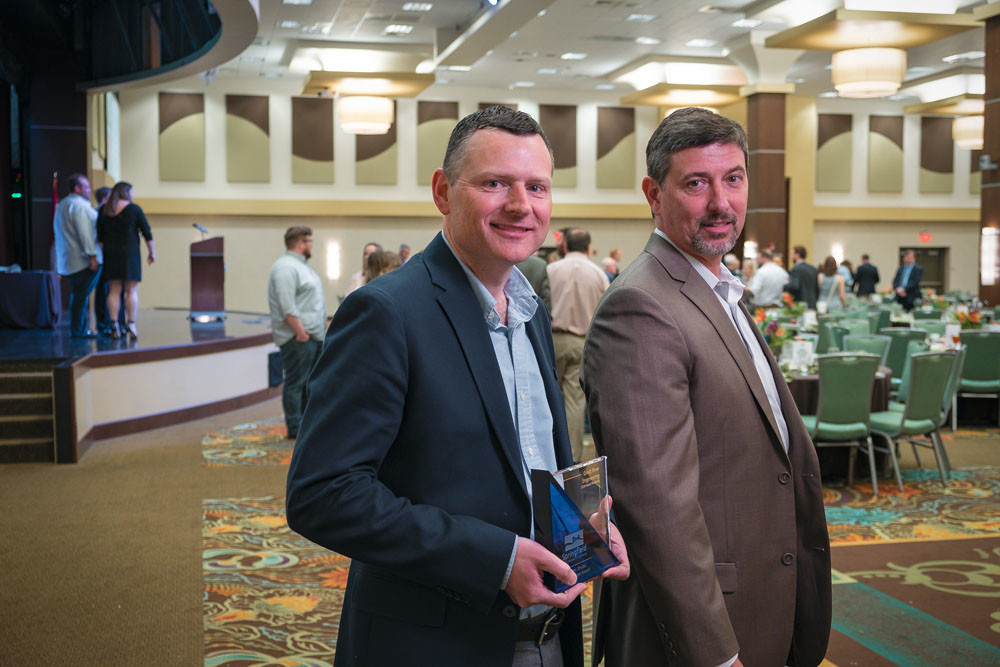 TOP HONOR: Great River Engineering principals Mel Eakins, left, and Spencer Jones accept the chamber’s 2018 W. Curtis Strube Small Business Award.